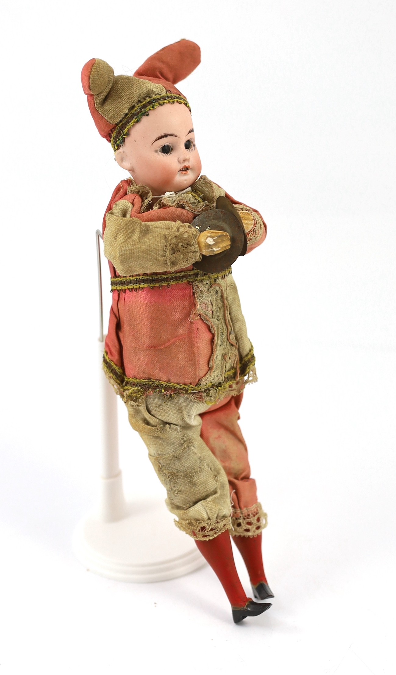 A bisque headed cymbal player, German, circa 1900, 12in.